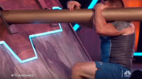 Man Doing Pull Ups on Wooden Wall Holding Pipe
