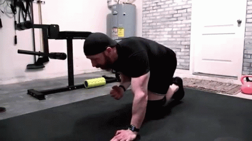 Man Doing Push Ups on Black Mat