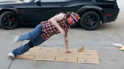 Man Doing Push Ups on Cardboard Box