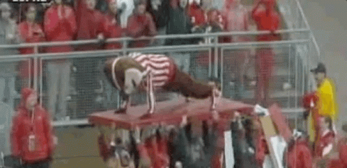 Man Doing Push Ups on Table in Front of Crowd