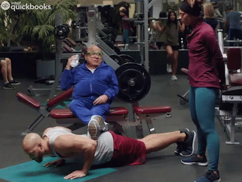 Man Doing Push Ups With QuickBooks Logo GIF