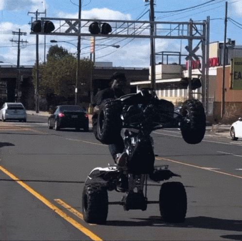 Man Doing Trick on ATV on Street