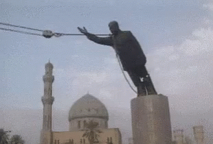 Man Doing Trick on Pole in Front of Mosque