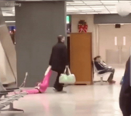 Man Dragging Someone On The Airport GIF