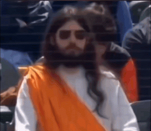 Man Dressed as Jesus in Sunglasses and Orange Robe