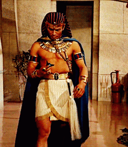 Man Dressed As Pharaoh Looking At Cell Phone GIF