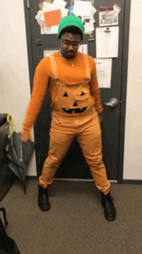 Man Dressed as Pumpkin Holding Umbrella