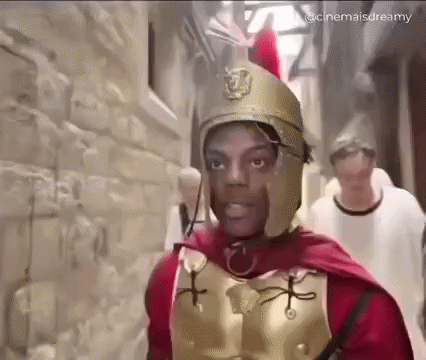 Man Dressed As Roman Soldier Walking Down Alley