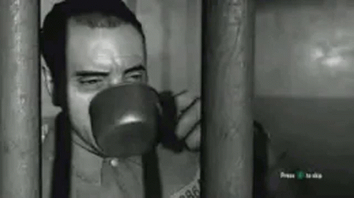 Man Drinking Behind Bars