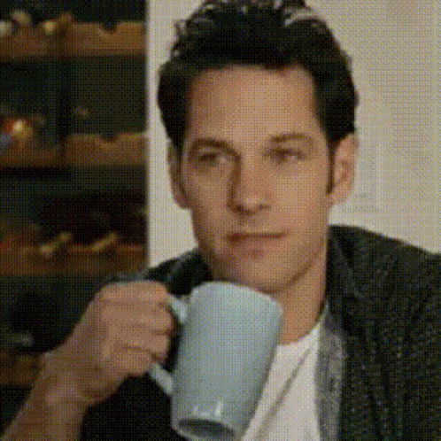 Man Drinking Coffee Looking at Camera