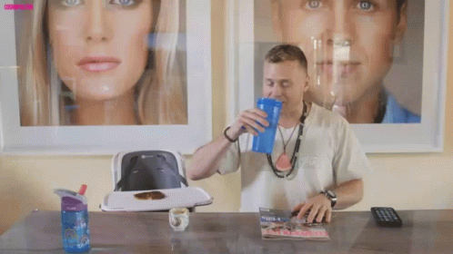 Man Drinking from Blue Cup