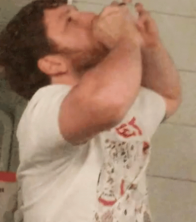 Man Drinking From Bottle In Bathroom GIF