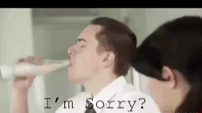 Man Drinking From Bottle While Woman Says I'm Sorry