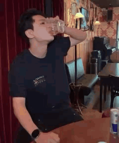Man Drinking from Glass at Bar