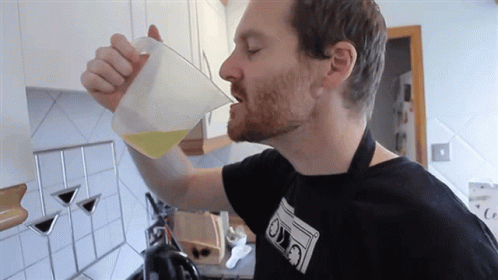 Man Drinking From Measuring Cup With Ovo Shirt