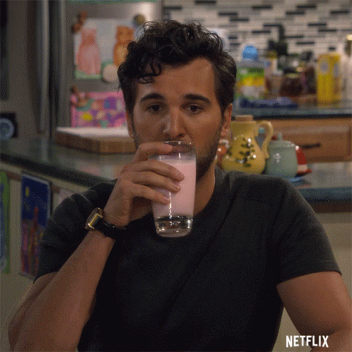 Man Drinking Glass With Netflix Logo