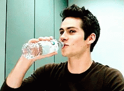 Man Drinking Water From Bottle With Letter O