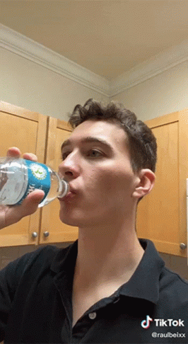 Man Drinking Water From Dolphins Bottle