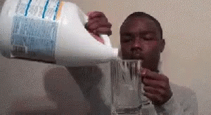 Man Drinking Water from Gallon Holding Glass