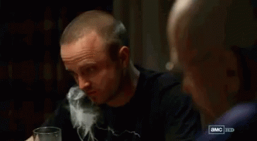 Man Drinking Water Watched by Another