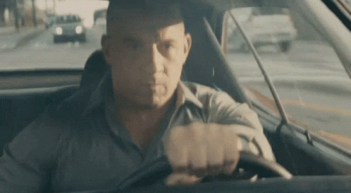 Man Driving Car Looking at Camera