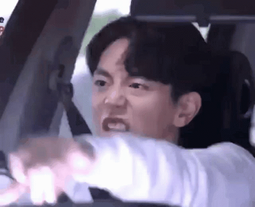 Man Driving Car Making Face