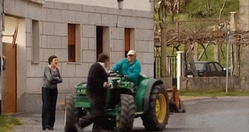 Man Driving Green John Deere Tractor