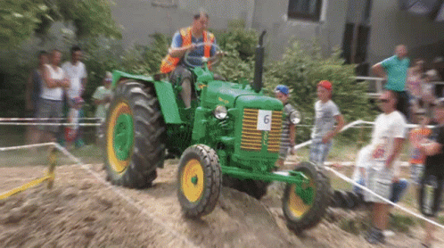 Man Driving Green Tractor Number 6