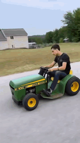 Man Driving John Deere Lawn Mower