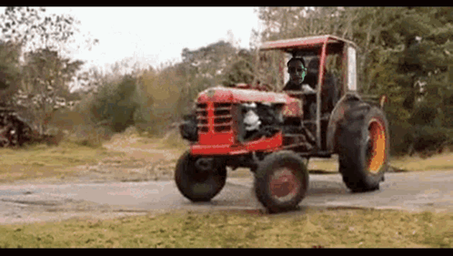 Man Driving Red Tractor