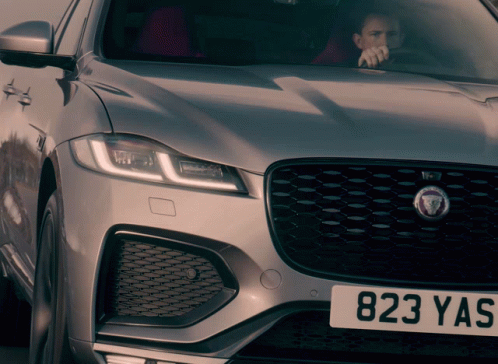 Man Driving Silver Jaguar With 823 Yas