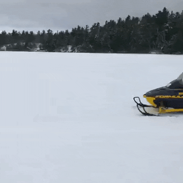 Man Driving Snowmobile With Bent Knees GIF