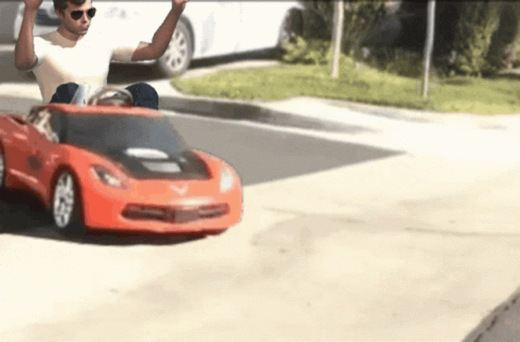 Man Driving With Toy Race Car GIF