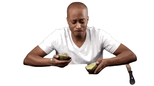 Man Eating Avocado With Knife and Fork