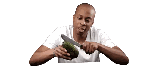 Man Eating Avocado With Knife