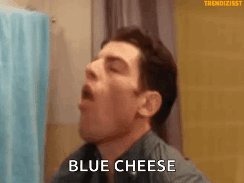 Man Eating Blue Cheese In Bathroom GIF