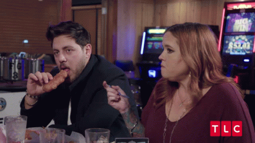 Man Eating Chicken Nugget Woman Looking TLC Logo