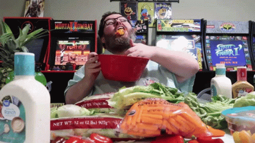 Man Eating Food in Front of Mortal Kombat Arcade Game