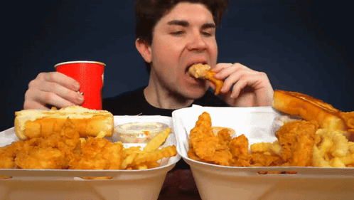 Man Eating Fried Chicken and French Fries
