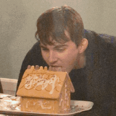 Man Eating Gingerbread House GIF