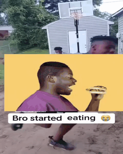 Man Eating Hamburger Next to Basketball Hoop