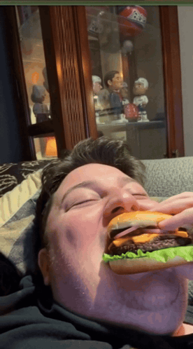 Man Eating Hamburger With Bobble Head Saying BB