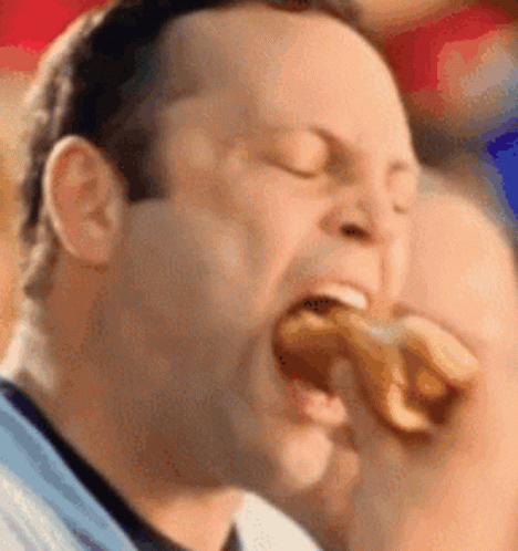 Man Eating Hot Dog With Eyes Closed