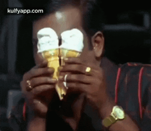 Man Eating Ice Cream Cone With Eyes Covered GIF