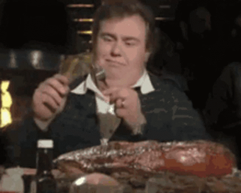 Man Eating Meat Holding Beer