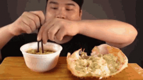 Man Eating Noodles With Crab GIF