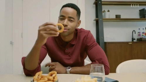 Man Eating Onion Rings and Drinking Water