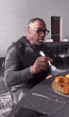 Man Eating Plate of Food with Fork