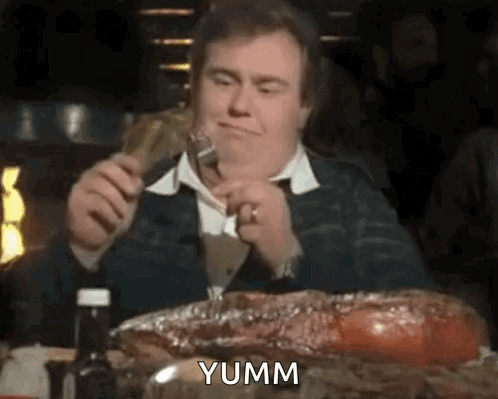 Man Eating Ribs with Fork and Knife