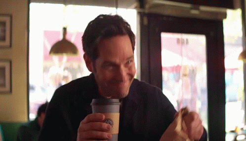Man Eating Sandwich and Drinking Starbucks Coffee